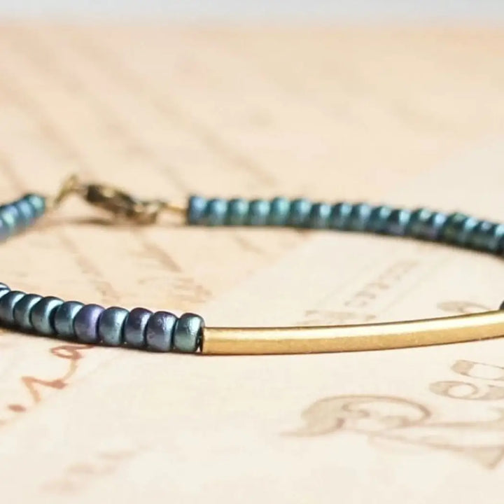 Metallic indigo blue seed bead, bronze bar bracelet